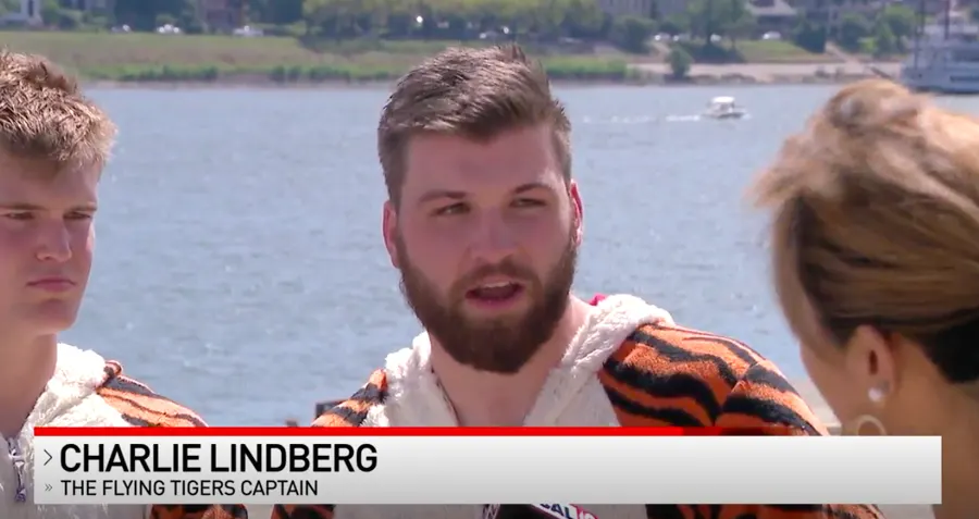 Charlie Lindberg in a tiger costume during a TV news interview on the riverfront.