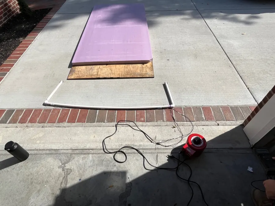 Hot wire foam cutter: a resistive wire strung across a PVC bow, connected to a power supply.